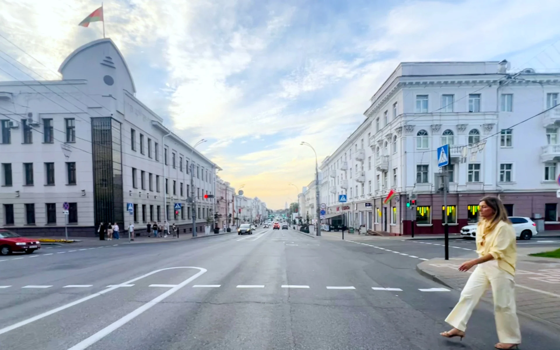 Svetlana outside walking across the street
